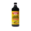 A bottle of bragg's liquid aminos soy protein seasoning front view angle